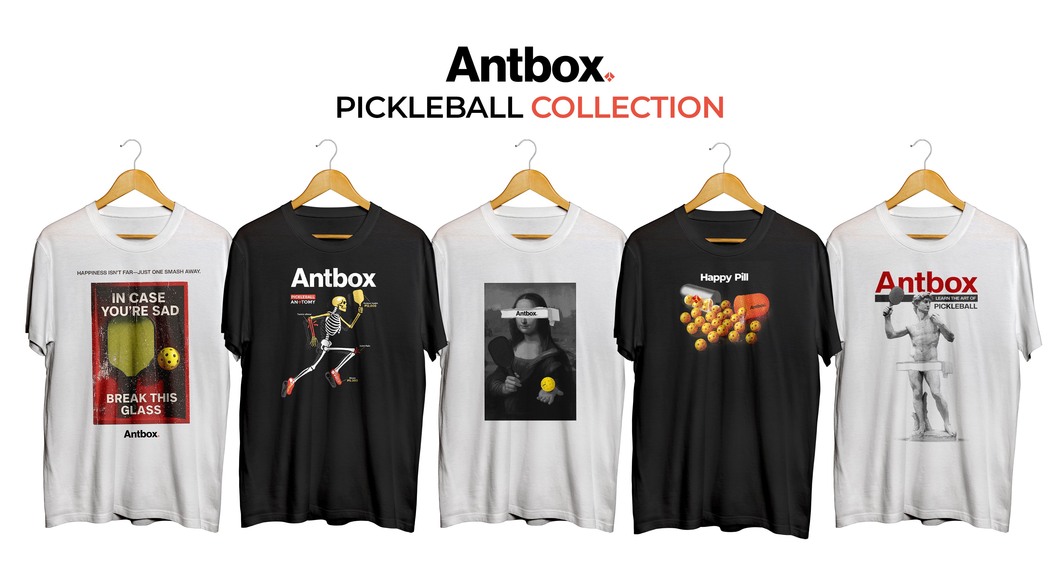 Collection of Antbox pickleball-themed t-shirts on hangers with the brand name displayed.