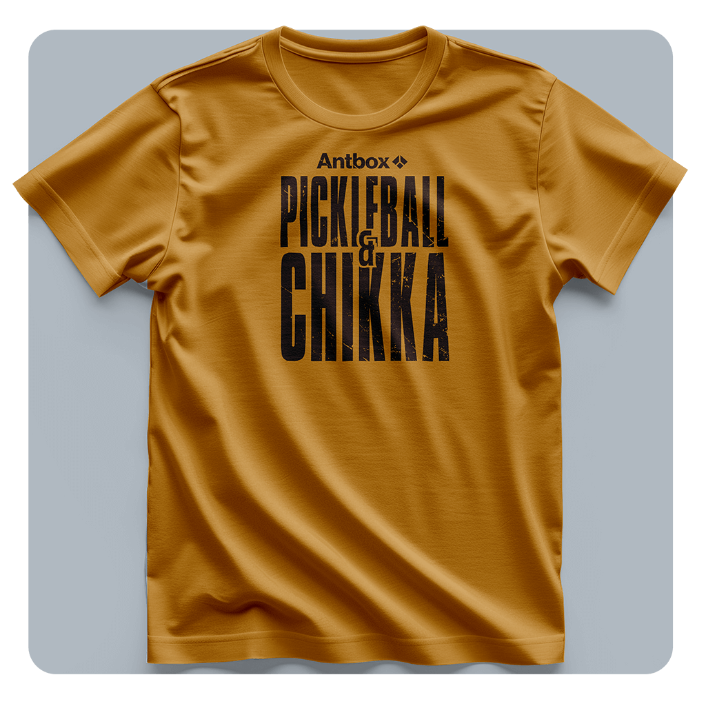 Mustard yellow t-shirt with black text on a light gray background