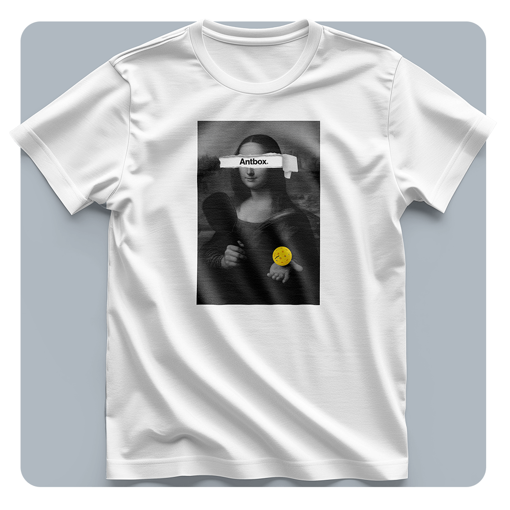 White t-shirt with a graphic design of a stylized Mona Lisa holding a baby on a gray background